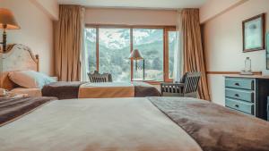Cama ou camas em um quarto em Wyndham Garden Ushuaia Hotel del Glaciar