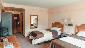 Cama ou camas em um quarto em Wyndham Garden Ushuaia Hotel del Glaciar