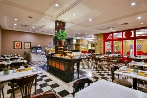 a restaurant with tables and chairs and a bar at Transamerica Executive Curitiba Batel in Curitiba