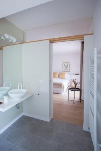 a bathroom with a sink and a bed in a room at Hotel Rural Mas de l'Illa in Tivissa