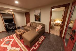 a living room with a couch and a tv at 180º Puget Sound View in Fox Island