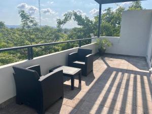 a patio with two chairs and a table on a balcony at Grann Hotel in Ciudad Valles