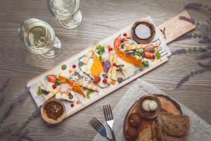 a table with a tray of food on it at Wellton Riga Hotel & SPA in Riga +44 photos