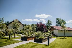 a garden in front of a house at Angermühle Landgasthof in Altenmarkt an der Alz