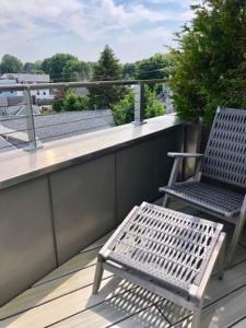 a bench and a chair on a balcony at 250 Main Hotel in Rockland