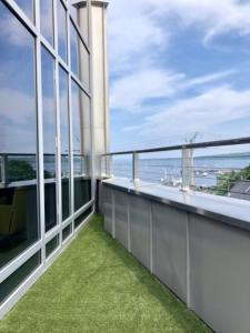 a grassy area with a fence and a balcony at 250 Main Hotel in Rockland