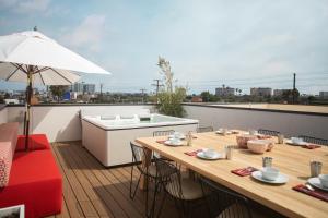 a patio with a table and a kitchen on a roof at Haven Coliving in Los Angeles
