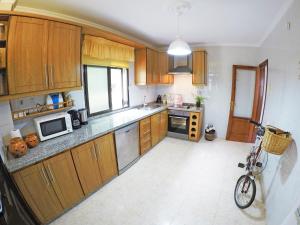 a kitchen with wooden cabinets and a bike parked in it at Casa El Cercado in Santa Cruz de Tenerife