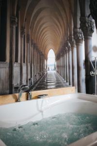 a bath tub in a building with water in it at Hotel Evianne Boutique in Galaţi