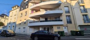 a black car parked in front of a building at Appart'Hôtel - Chateaubriant in Châteaubriant