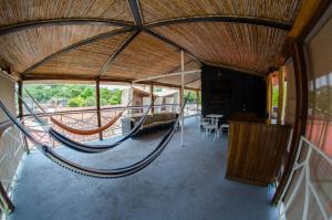 a large room with a hammock in a house at El Caite San Juan del Sur in San Juan del Sur