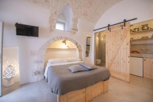a hotel room with a large bed and a large window at CASA FLAMI' in Ostuni