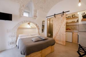 a bedroom with a large bed in a room at CASA FLAMI' in Ostuni