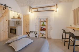 a kitchen with a bed and a table at CASA FLAMI' in Ostuni