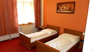 Posteľ alebo postele v izbe v ubytovaní Hotel Maria