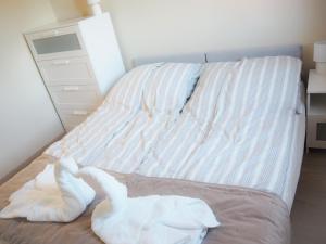 Posteľ alebo postele v izbe v ubytovaní Holiday Apartmanház