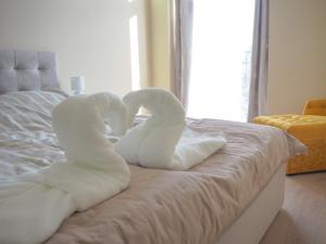 Posteľ alebo postele v izbe v ubytovaní Holiday Apartmanház