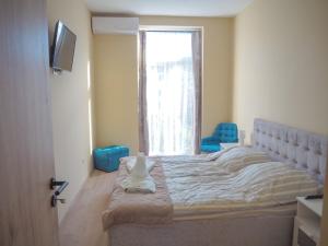 Posteľ alebo postele v izbe v ubytovaní Holiday Apartmanház