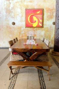 a wooden table and chairs in a room at Espectacular Troncones Estate with 360 degree Views - 5 minute walk from the main surf break in Troncones