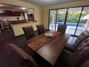a dining room with a wooden table and chairs at La Quinta de Don Hugo in Ixtapa +6 photos