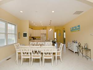 a dining room and kitchen with a white table and chairs at Bayside Resort - 36477 Wild Rose in Selbyville