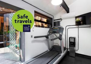 a treadmill in a trailer with a sign that reads safe travels at Hotel MX aeropuerto in Mexico City