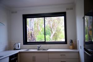 a kitchen with a sink and a large window at 151 Grampians Road in Halls Gap