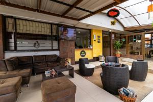 a living room with couches and chairs and a television at Ayenda 1087 La Estacion in Bogotá
