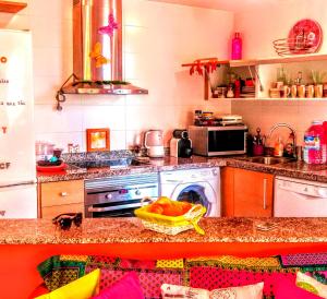 a kitchen with a stove and a washing machine at Deluxe garden flat near Terra-Mítica in Benidorm