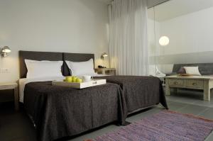 a bedroom with a bed with a tray of fruit on it at Filoxenia Apartments in Agia Pelagia Kythira +51 photos
