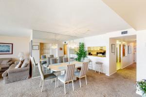 a dining room and living room with a table and chairs at Sea Colony Edgewater House IV in Bethany Beach