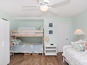a bedroom with two bunk beds and a ceiling fan at Sea Colony Edgewater House VI in Bethany Beach +30 photos