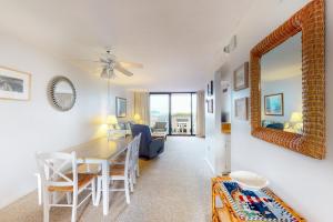 a dining room and living room with a table and chairs at Sea Colony Georgetowne House in Bethany Beach