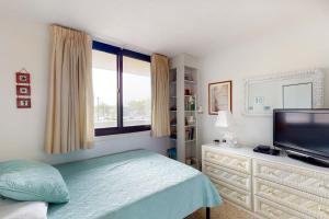 a bedroom with a bed and a flat screen tv at Sea Colony Georgetowne House in Bethany Beach