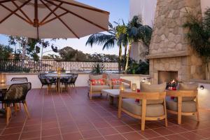 un patio con mesas y sillas y una chimenea en Hyatt Place Santa Barbara, en Santa Bárbara