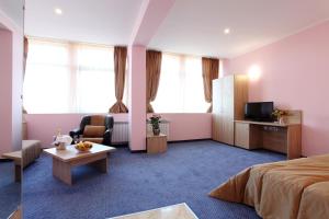 Cette chambre comprend un lit et une télévision. dans l'établissement Teodora Palace Hotel, à Ruse