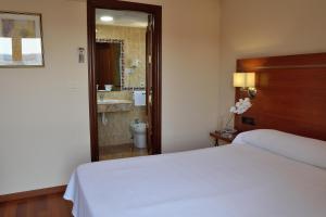 Postel nebo postele na pokoji v ubytování Hotel Mari Carmen