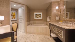 
a bathroom with a sink and a bathtub at Paris Las Vegas Hotel & Casino in Las Vegas
