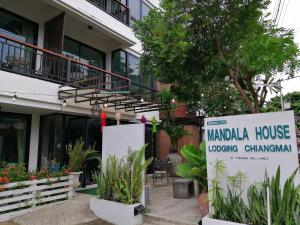 a sign in front of a building with a sign for a marmalka house at Mandala House, Chiang Mai in Chiang Mai