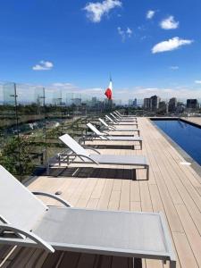 a row of lounge chairs on the roof of a building at Galeria Plaza San Jeronimo in Mexico City