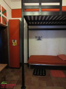 a bedroom with a bunk bed with a red mattress at Host Historic Centre Naples in Naples