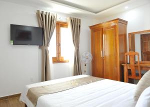 Ένα ή περισσότερα κρεβάτια σε δωμάτιο στο Khách sạn KIM NGÂN