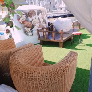 two wicker chairs and a table and a couch at The Antique in Busan