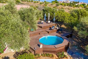 an overhead view of a swimming pool with a wooden deck at Lagonisi Villa Afroditi in Lagonissi