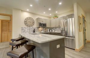 a kitchen with a large counter and a clock on the wall at Cs302 Copper Springs Condo in Copper Mountain