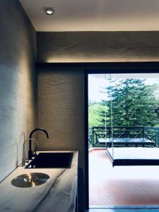 a bathroom with a sink and a large window at 80 Colonie Fraser's Hill in Bukit Fraser