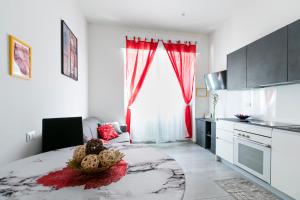 a bedroom with a large bed with red curtains at Marconi Dreams in Bologna