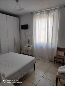 A bed or beds in a room at Casa di Alfredo Affittacamere