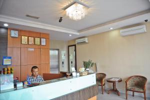 a man sitting at a counter in a restaurant at Hotel Centum in Klang