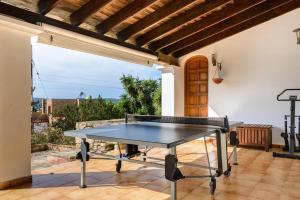 a ping pong table on the patio of a house at Cas BAYAROL in Santa Eularia des Riu